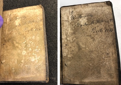 Round stains on the front cover page indicating mould