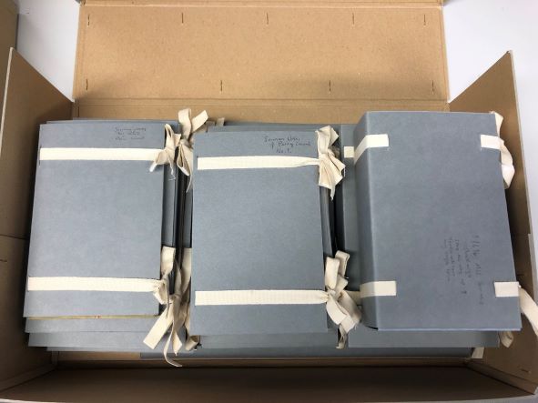The loose volumes now have their own small grey boxes and cotton tape, returned to the brown archival box.