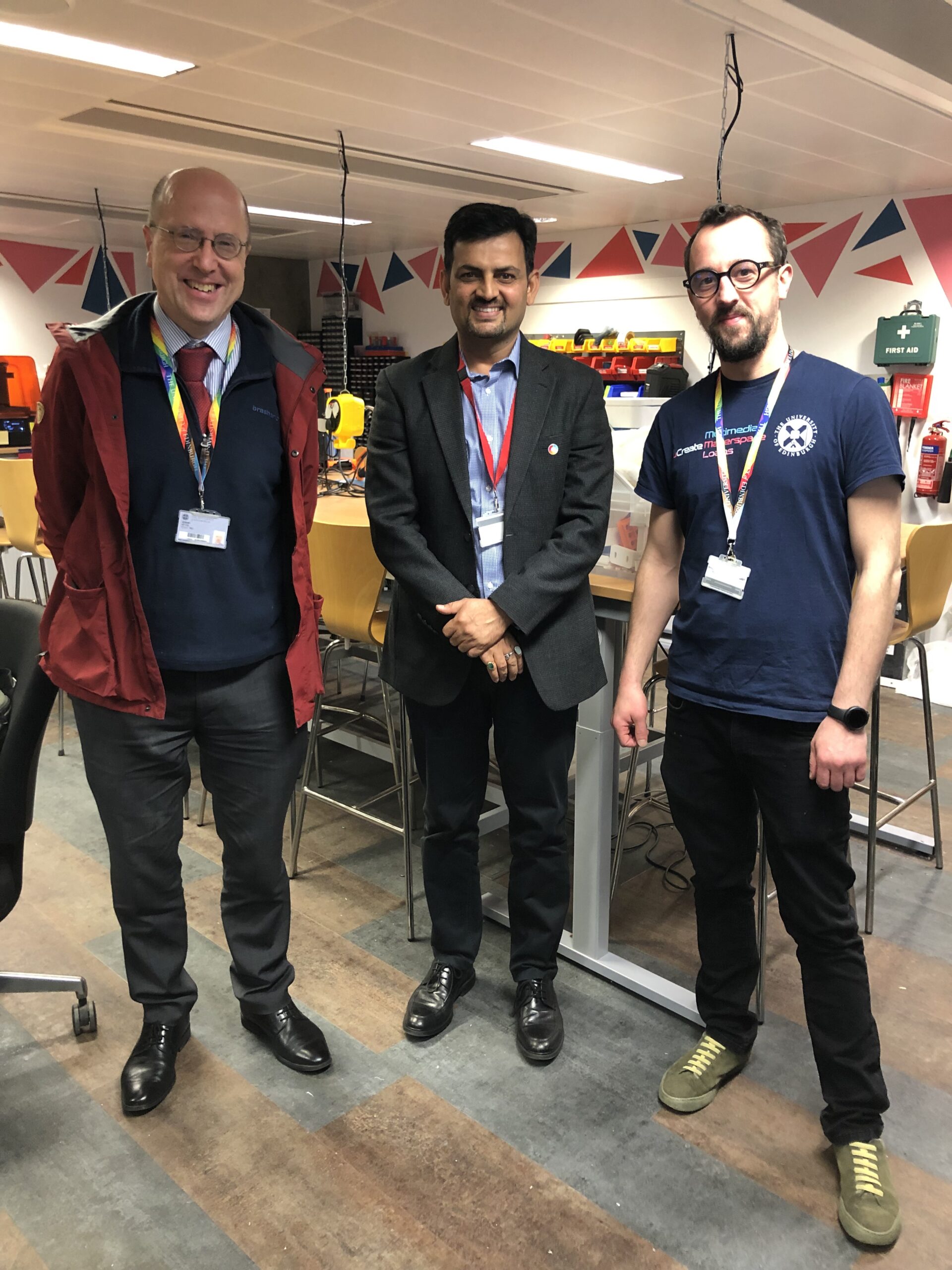 3 men standing in the Makerspace.