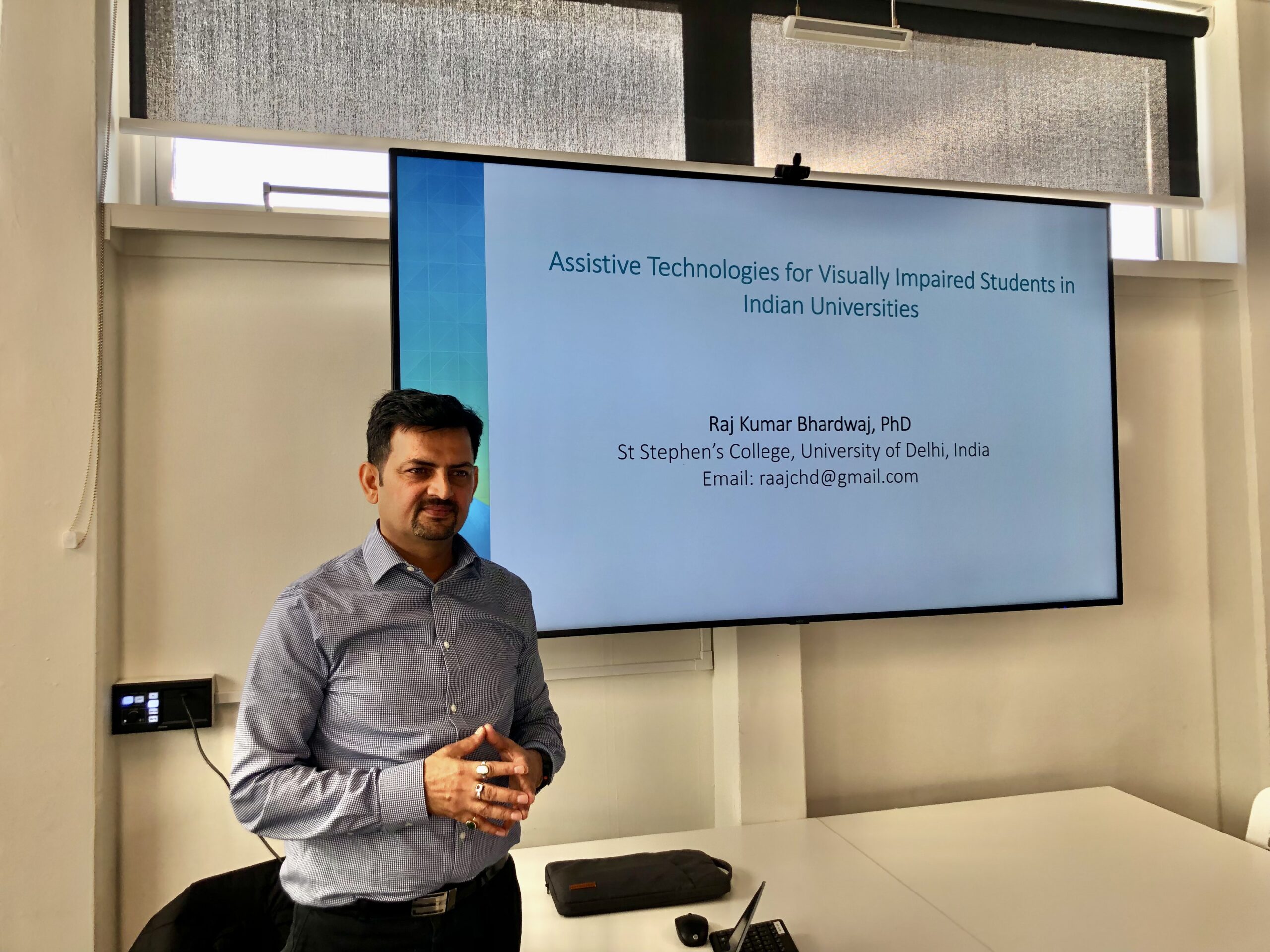 Raj and his slide, entitled "Assistive Technologies for Visually Impaired Students in Indian Universities."