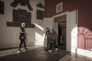 3 students in the entrance of the Law Library, in the Old College
